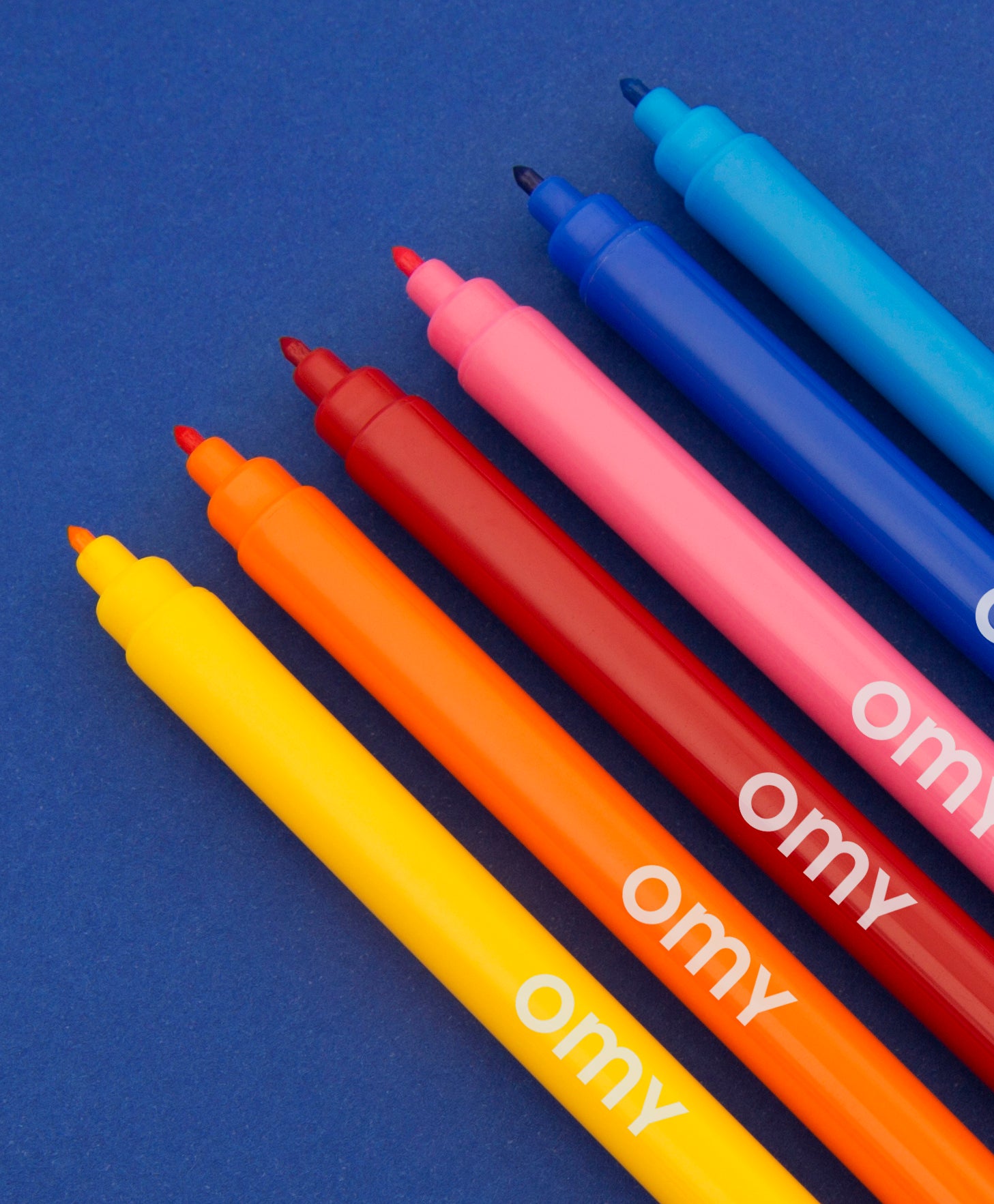 OMY Ultra-Washable Markers — child colouring on an OMY poster