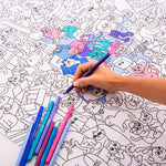 OMY Kitty — child colouring on the poster spread out on the floor
