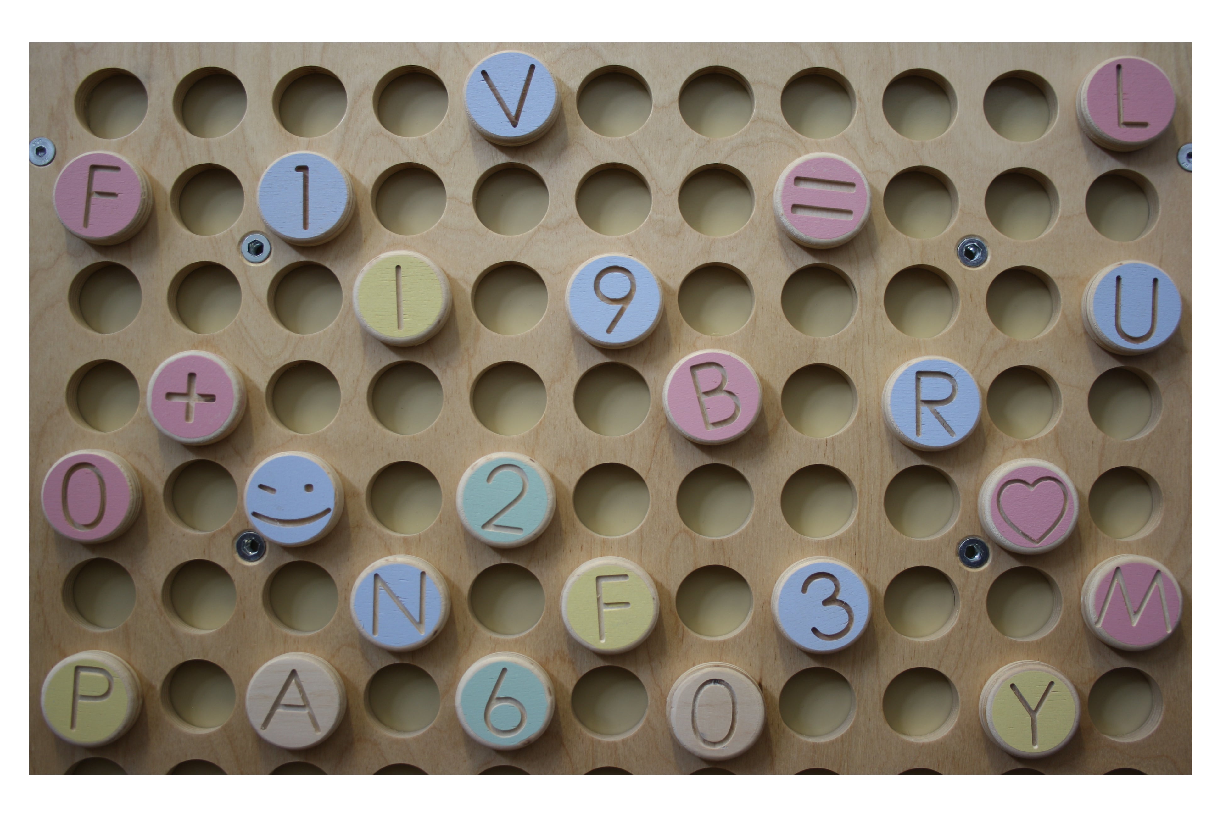 Petinka wooden letters, numbers and shapes arranged on the magnetic wall board