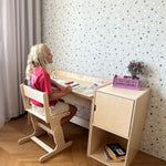 Child studying at the AGGIE desk with AGGIE chair and cabinet