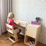 Child studying at the AGGIE desk with AGGIE chair and cabinet