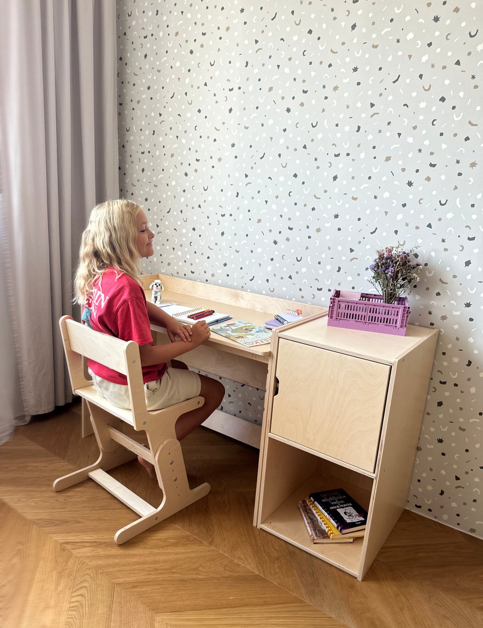 Child studying at the AGGIE desk with AGGIE chair and cabinet