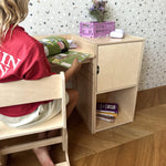 Child sitting on the AGGIE growing chair at the AGGIE desk