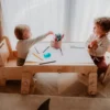 kids playing with paper roll with table holder